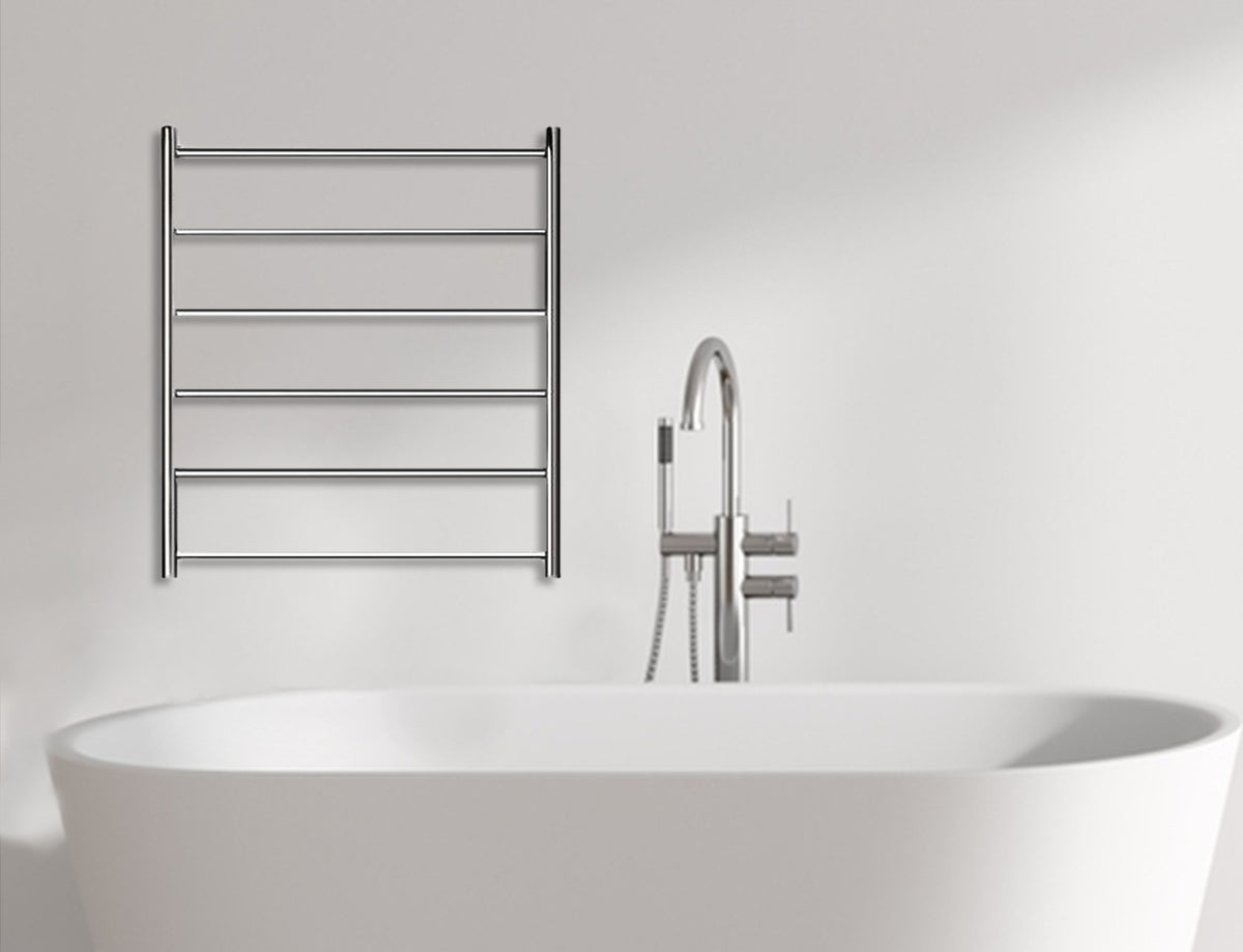 Chrome heated towel rail on a white bathroom wall above a freestanding bath